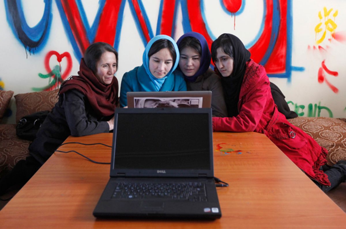 Afghan girls work at an internet cafe for women in Kabul, March 8, 2012.   (Reuters/Mohammad Ismail)
