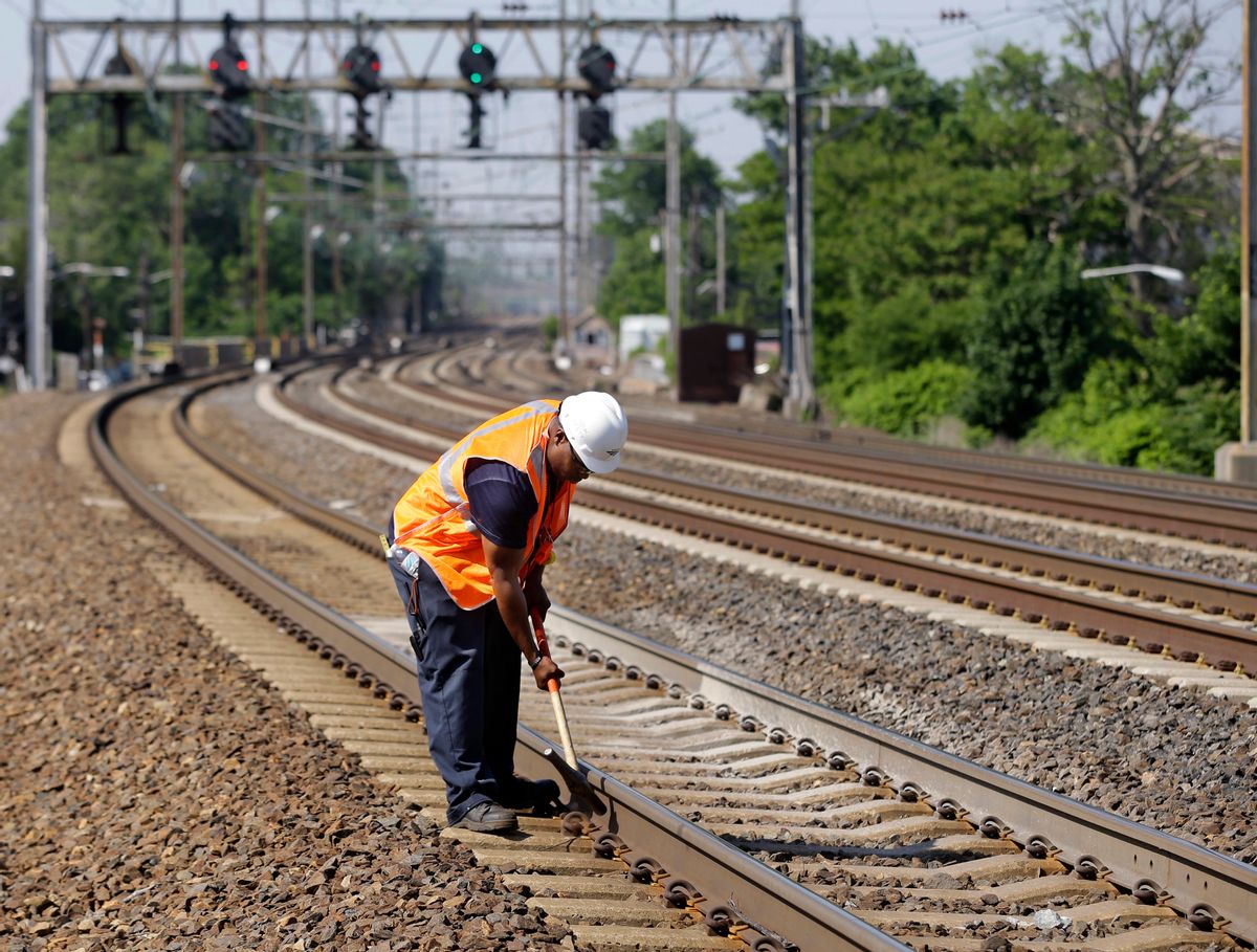 FILE - In this Thursday, May 30, 2013 file photo, Amtrak worker Rich Woolfolk checks railroad tracks along the Northeast Corridor in Elizabeth, N.J. (AP Photo/Mel Evans) (AP)