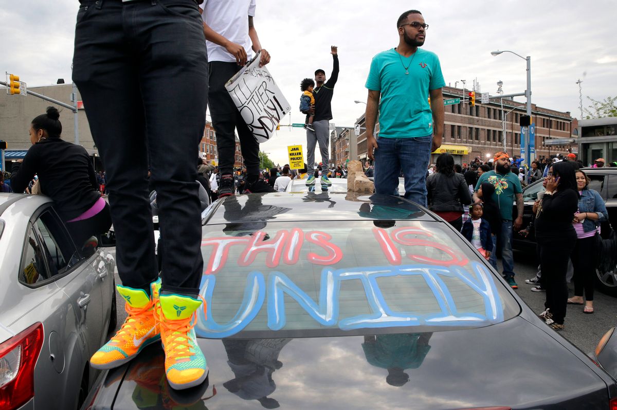 Protesters stand on cars near the intersection of North Avenue and Pennsylvania Avenue in Baltimore, Friday, May 1, 2015, the day of the announcement of charges against the police officers involved in Freddie Gray's arrest. State's Attorney Marilyn Mosby announced the stiffest charge, second-degree "depraved heart" murder, against the driver of the police van that Gray was in after his arrest. Other officers faced charges of involuntary manslaughter, assault and illegal arrest. (AP Photo/Patrick Semansky)  (AP)