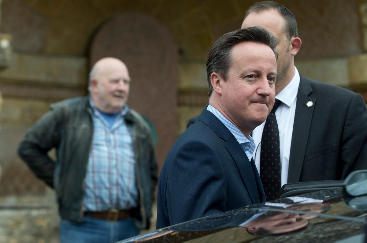Britain's Prime Minister and Conservative Party leader David Cameron gets in his official car after voting at a polling station in Spelsbury, England, in the general election, Thursday, May 7, 2015. Polls have opened in Britain's national election, a contest that is expected to produce an ambiguous result, a period of frantic political horse-trading and a bout of national soul-searching.   (AP Photo/Alastair Grant) (AP)