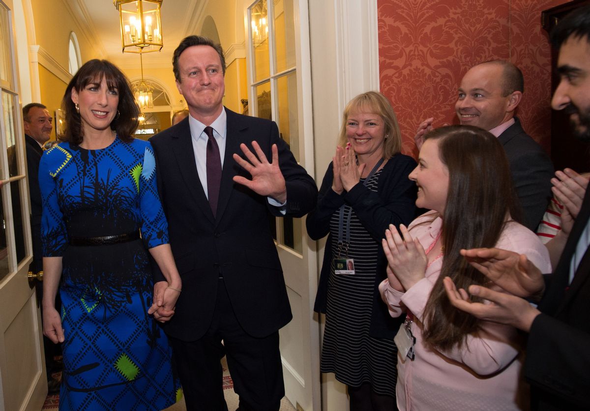 Britain's Prime Minister David Cameron and his wife Samantha are applauded by staff upon entering 10 Downing Street in London Friday May 8 2015, as he begins his second term as Prime Minister following the Conservative Party's win in Thursday's General Election . (Stefan Rousseau/Pool Photo via AP) (AP)