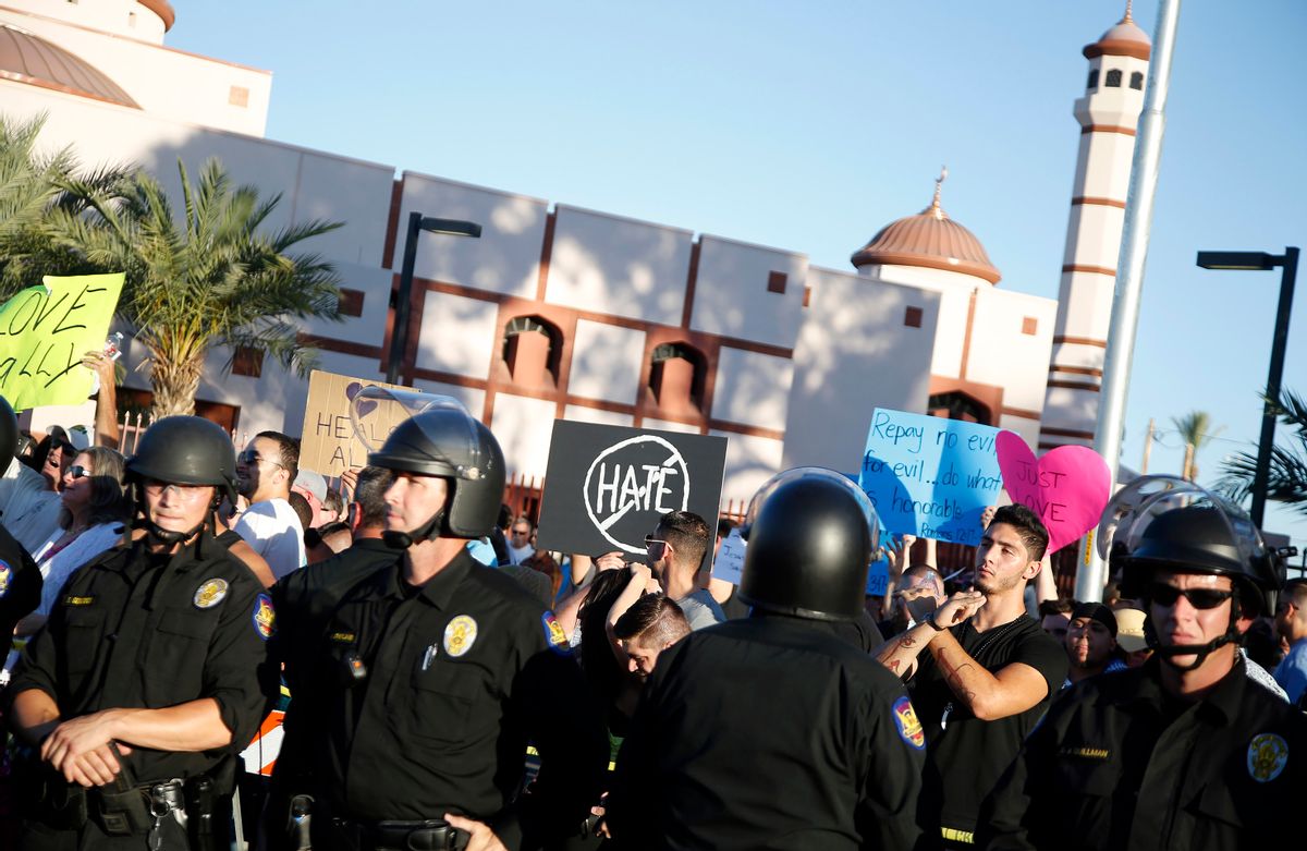 Protesters gather outside the Islamic Community Center of Phoenix, Friday, May 29, 2015. About 500 protesters gathered outside the Phoenix mosque on Friday as police kept two groups sparring about Islam far apart from each other.  (AP Photo/Rick Scuteri) (AP)