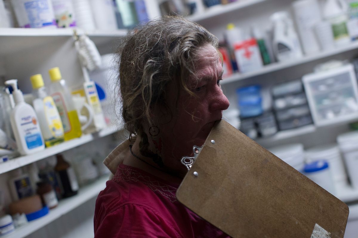 In this Thursday, May 7, 2015 photo, Victoria Goss, founder of Last Chance Corral, stands in the medical supply room as she waits for the result of a colostrum test in Athens, Ohio. Every new foal brought to rescue critical for the development of animal's immune system. In some cases, the foal is separated from the mother before the antibody transfer occurs, requiring intervention at the rescue. (AP Photo/John Minchillo) (AP)