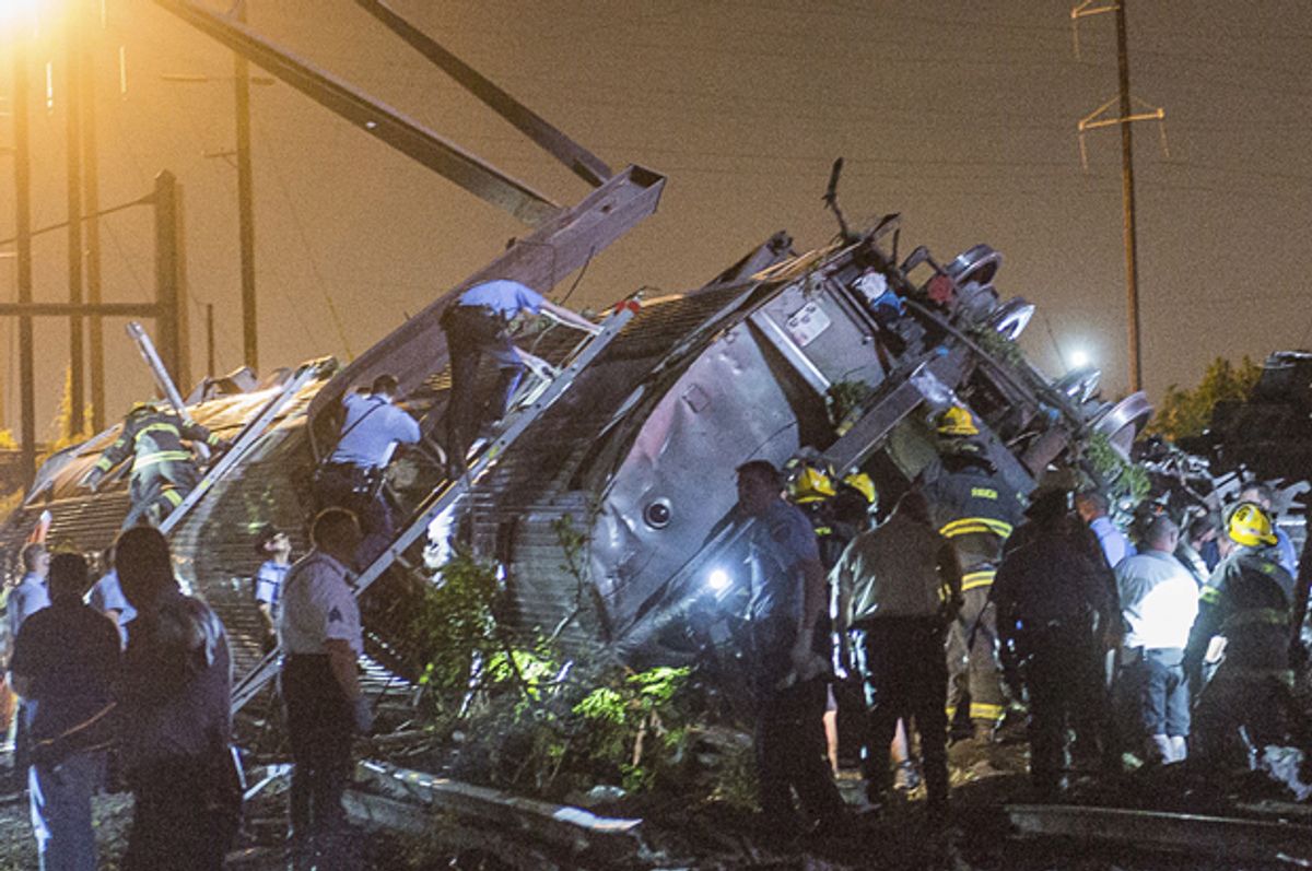 Rescue workers search for victims in the wreckage of a derailed Amtrak train in Philadelphia, Pennsylvania May 12, 2015.       (Reuters/Bryan Woolston)