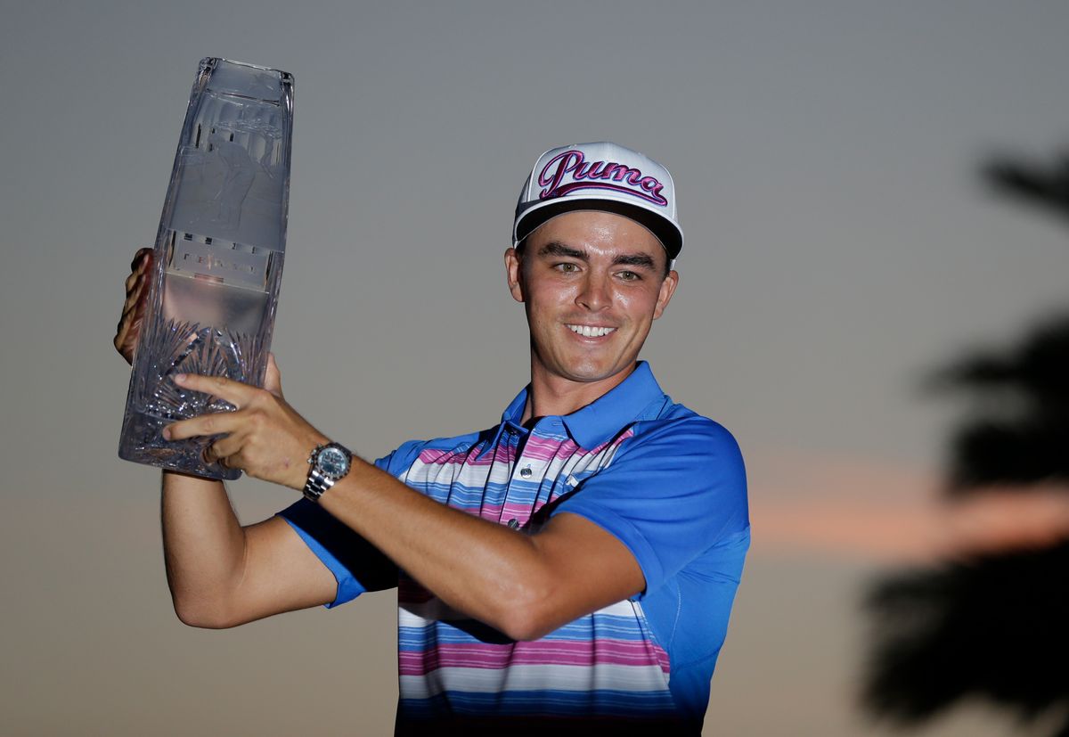 Rickie Fowler holds during the The Players Championship trophy, Sunday, May 10, 2015, in Ponte Vedra Beach, Fla. Fowler won in a sudden death playoff against Kevin Kisner. (AP Photo/John Raoux) (AP)