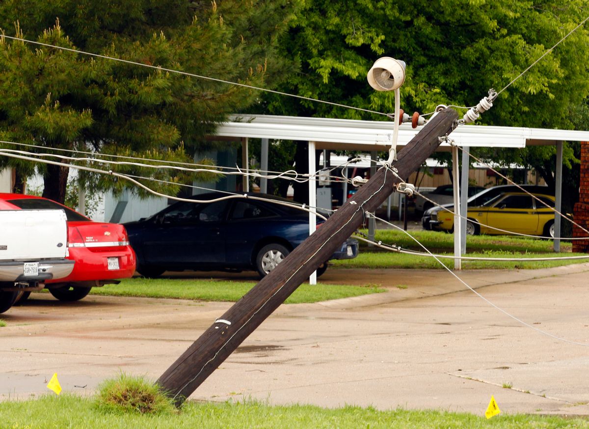 A power pole leans along Fort Worth Avenue after a storm in Denton, Texas, Sunday, May 10, 2015. Several Great Plains and Midwest states were in the path of severe weather, including in North Texas, where the National Weather Service said a likely tornado damaged roofs and trees near Denton. (Richard W. Rodriguez/The Fort Worth Star-Telegram via AP)  MAGS OUT; (FORT WORTH WEEKLY, 360 WEST); INTERNET OUT (AP)