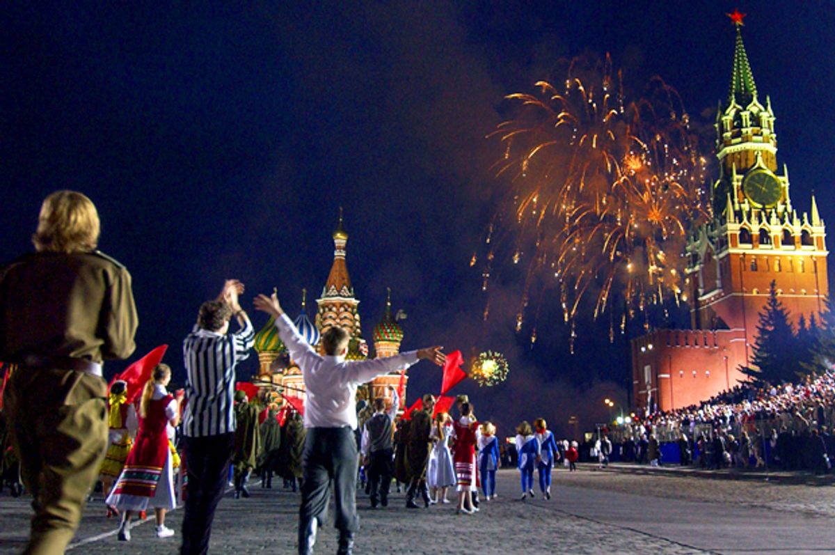 People celebrate as fireworks explode over the Kremlin to mark the 60th anniversary of the Allies' victory over Nazi Germany near the Red Square in Moscow, May 9, 2005.     (AP)