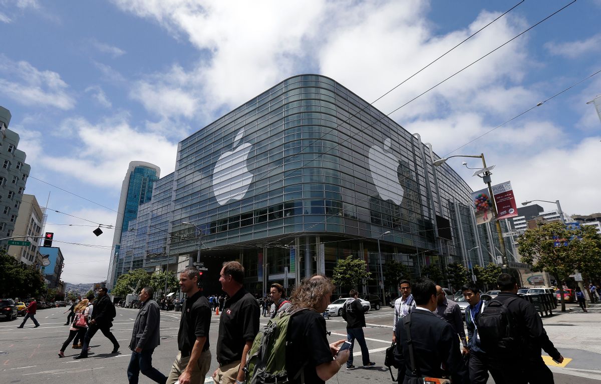 FILE - In this June 2, 2014 file photo, pedestrians cross the street in front of the Moscone Center, which is hosting the Apple Worldwide Developers Conference, in San Francisco. Apple is expected to announce its new paid streaming-music service at its annual conference for software developers, which kicks off Monday, June 8, 2015. (AP Photo/Jeff Chiu, File) (AP)