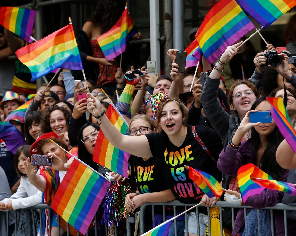 A crowd waves rainbow flags during the Heritage Pride March in New York, Sunday, June 28, 2015. Large turnouts were expected for gay pride parades across the U.S. following the landmark Supreme Court ruling that said gay couples can marry anywhere in the country. (AP Photo/Kathy Willens) (AP)