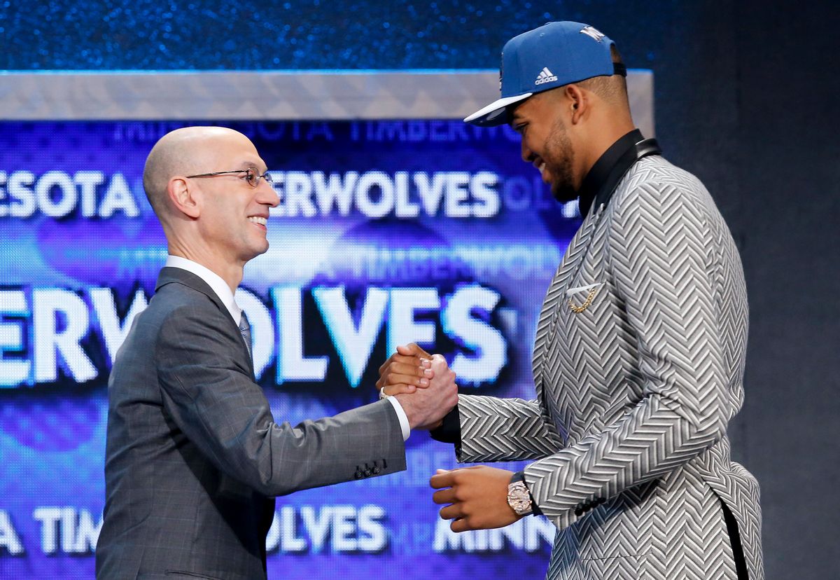 Karl-Anthony Towns, right, is greeted by NBA Commissioner Adam Silver after being announced as the top pick, by the Minnesota Timberwolves, at the NBA basketball draft Thursday, June 25, 2015, in New York. (AP Photo/Kathy Willens) (AP)