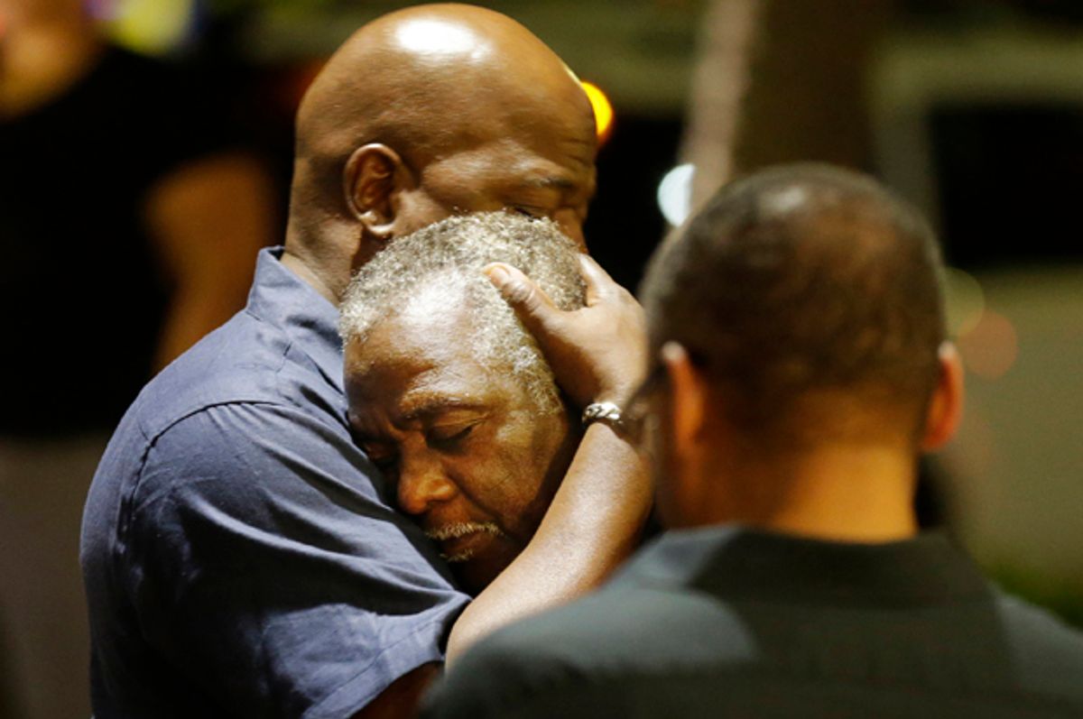 Worshippers embrace across the street from the scene of a shooting at Emanuel AME Church, Wednesday, June 17, 2015, in Charleston, S.C.        (AP/David Goldman)