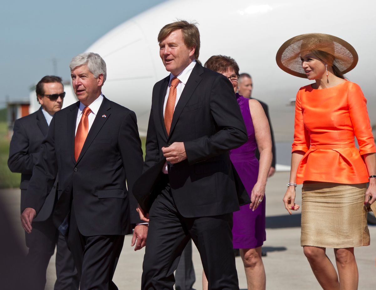 Dutch King Willem-Alexander, center, and Queen Maxima, right, walk near Gov. Rick Snyder after arriving at the Gerald R. Ford International Airport in Grand Rapids, Mich., Tuesday, June 2, 2015. Plans call for a luncheon with Gov. Snyder and visits with local leaders. The king and queen leave Tuesday afternoon for Chicago. The king and his wife are on a multi-day trip to the U.S. (Cory Morse/The Grand Rapids Press via AP) ALL LOCAL TELEVISION OUT; LOCAL TELEVISION INTERNET OUT (AP)