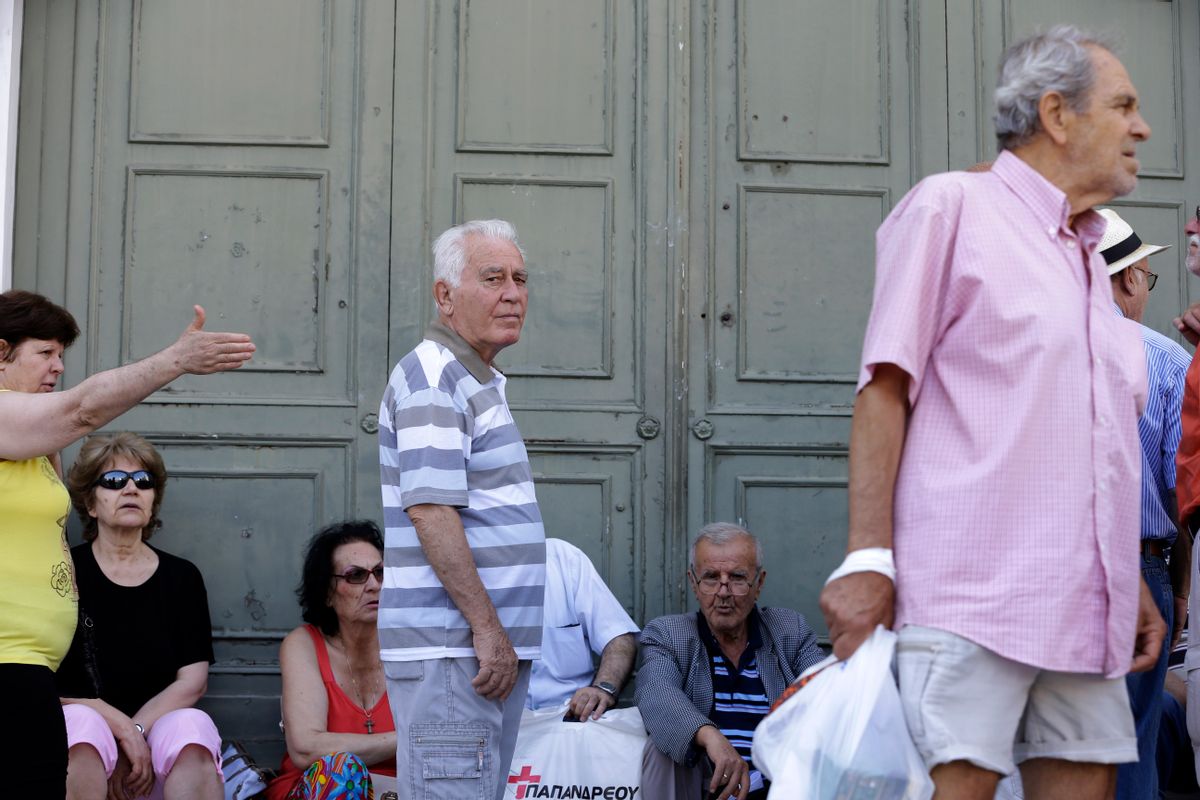 Elderly people, who usually get their pensions at the end of the month, wait outside a closed bank in Athens, Monday, June 29, 2015. Greece's five-year financial crisis took its most dramatic turn yet, with the cabinet deciding that Greek banks would remain shut for six business days and restrictions would be imposed on cash withdrawals. (AP Photo/Thanassis Stavrakis) (AP)