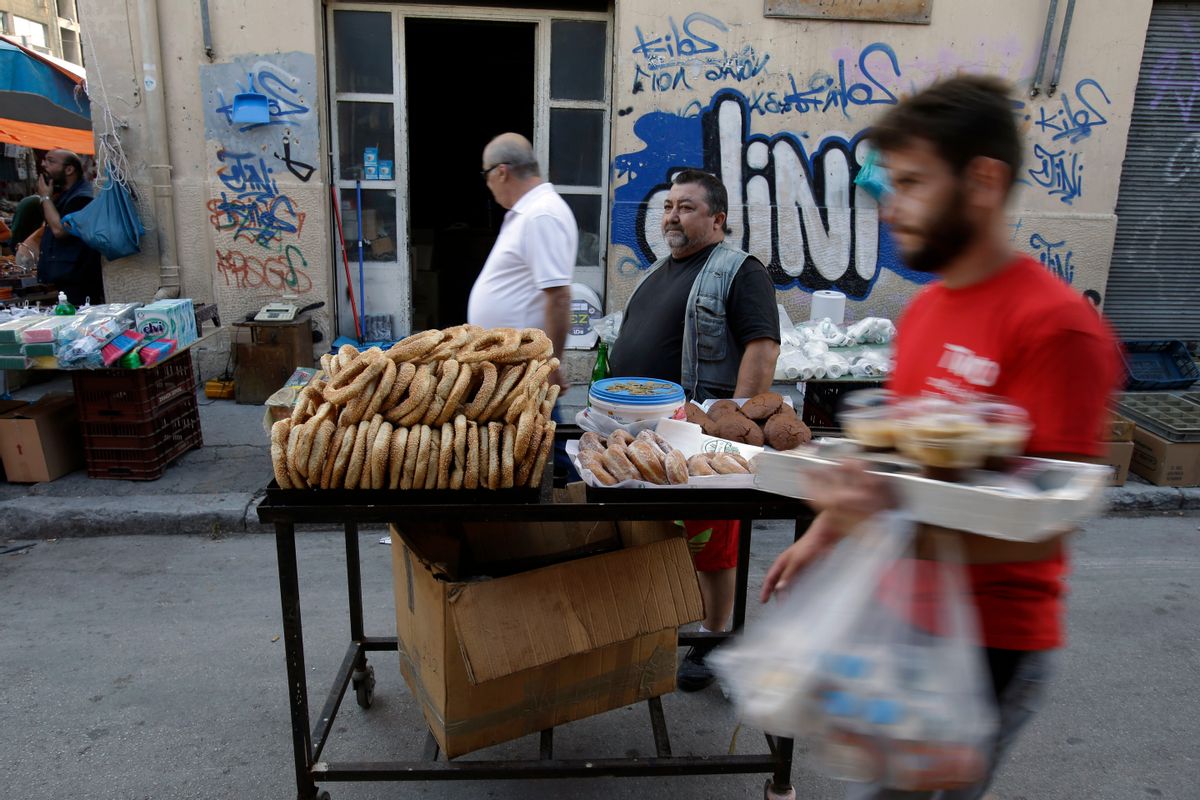 A man sells bread rings and donuts at a flea market in the port of Piraeus, near Athens, Sunday, June 28, 2015. (AP Photo/Thanassis Stavrakis) (Thanassis Stavrakis)