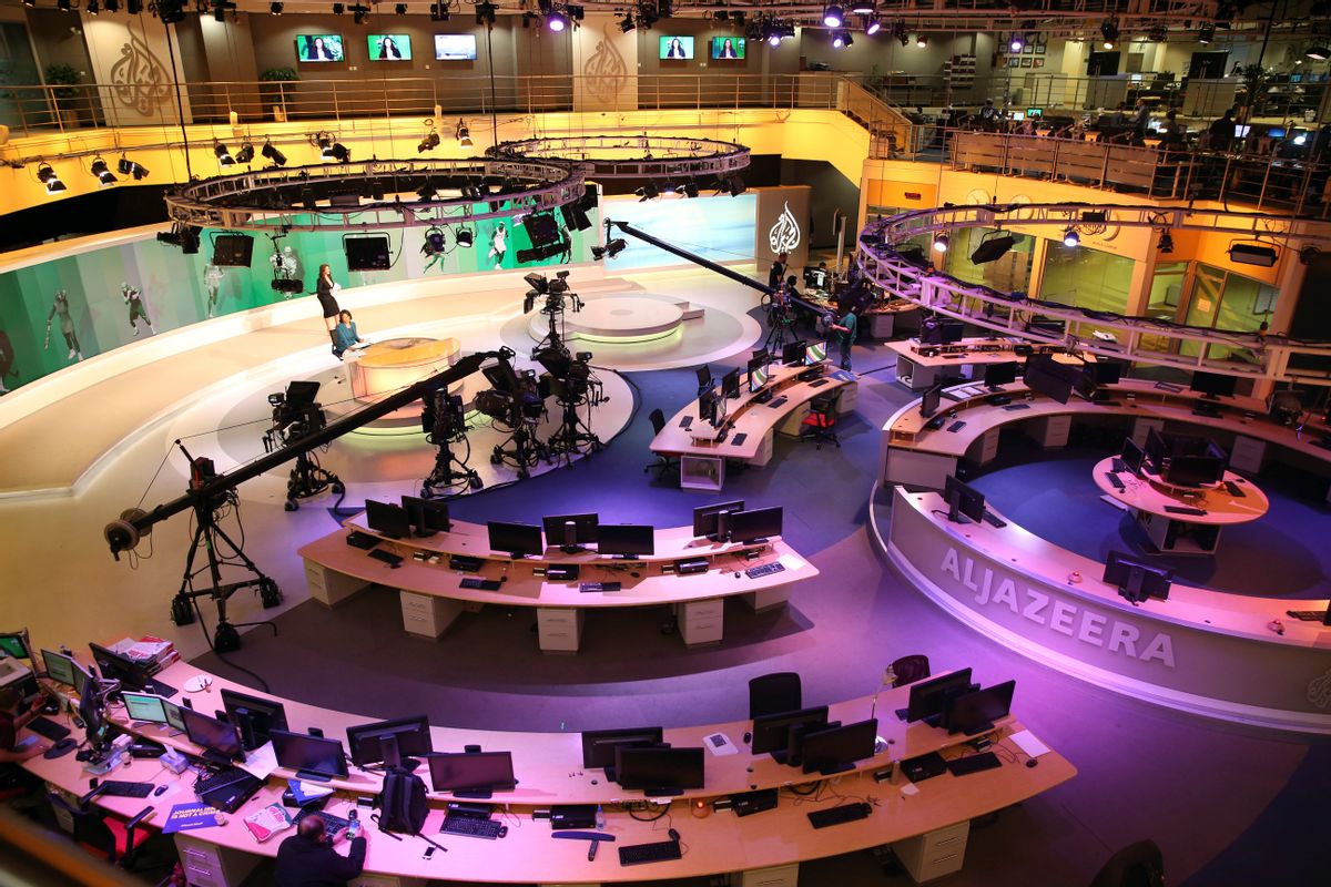 FILE- In this Jan. 1, 2015, file photo, staff members of Al-Jazeera International work at the news studio in Doha, Qatar.  (AP Photo/Osama Faisal, File)