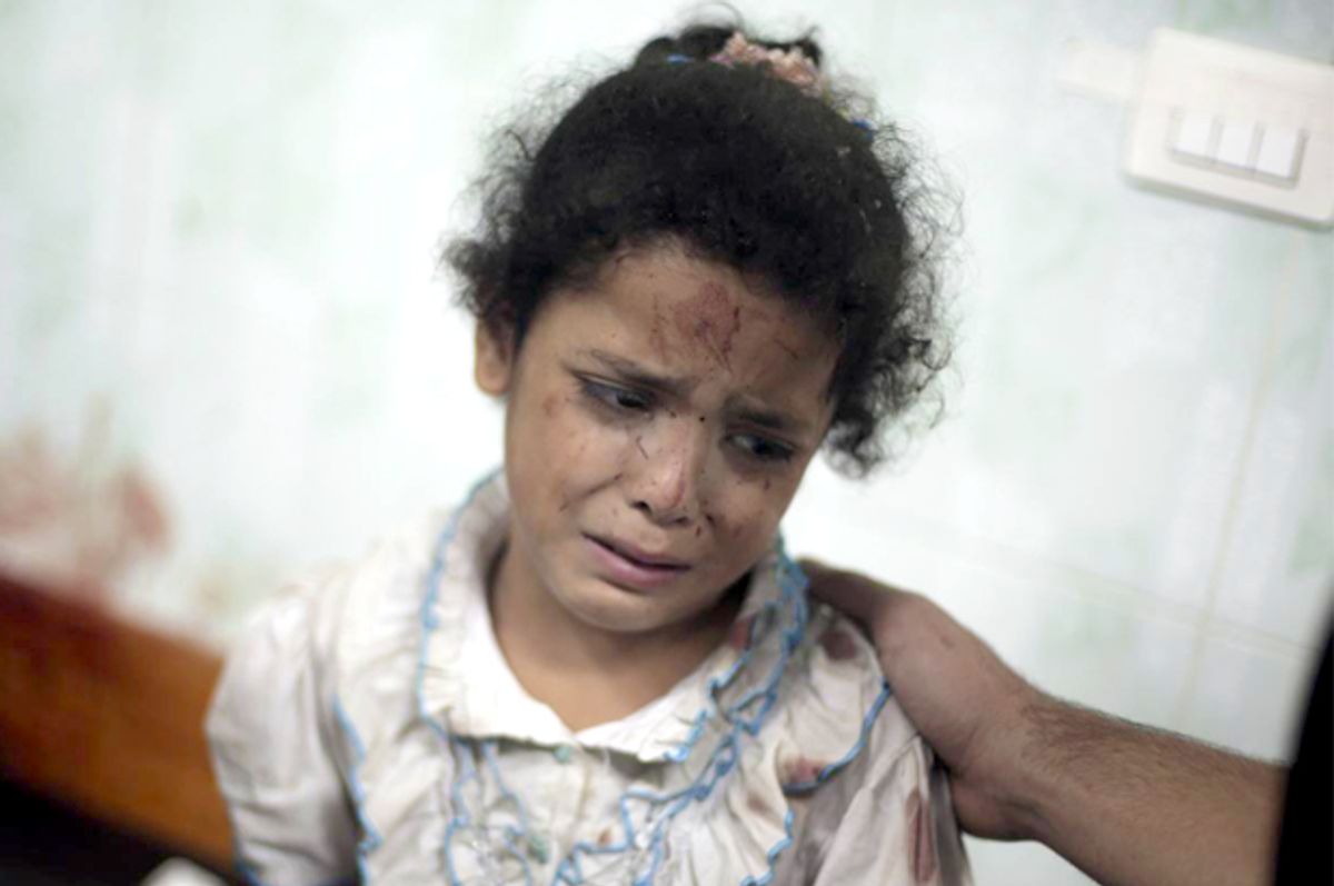 A Palestinian girl cries while receiving treatment for her injuries caused by a 2014 Israeli strike at a U.N. school in Jebaliya refugee camp, at the Kamal Adwan hospital in Beit Lahiya, northern Gaza Strip.      (AP/Khalil Hamra)