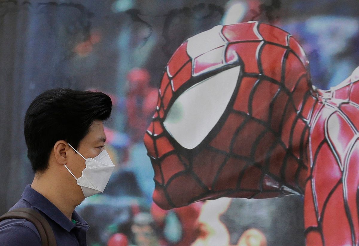 A South Korean man wearing a mask as a precaution against the Middle East Respiratory Syndrome virus walks by a Spider-Man poster advertising a musical for children in Seoul, South Korea Wednesday, June 10, 2015. MERS has infected nearly 100 and caused nine deaths in South Korea, but experts say the virus mainly spreads through close contact with an infected person. (AP Photo/Ahn Young-joon) (Ahn Young-joon)