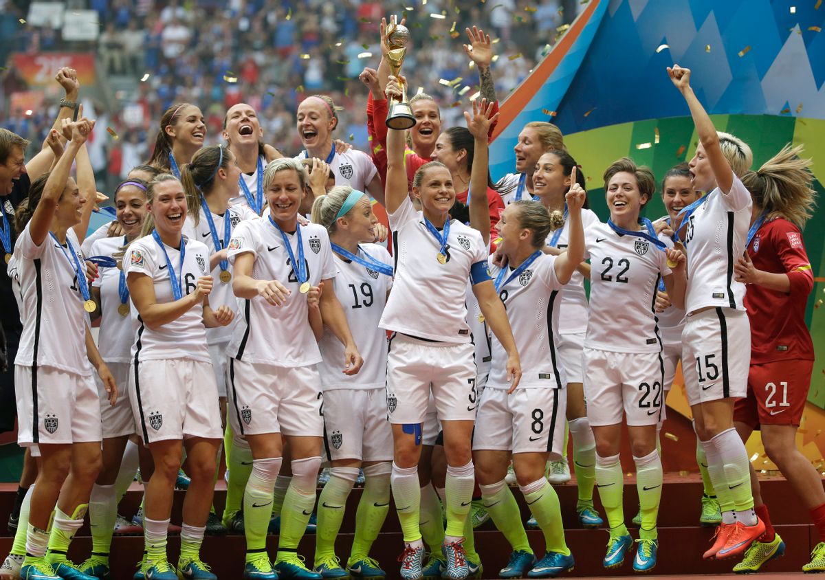 The United States Women's National Team celebrates with the trophy after they beat Japan 5-2 in the FIFA Women's World Cup soccer championship in Vancouver, British Columbia, Canada, Sunday, July 5, 2015. (AP Photo/Elaine Thompson)    (AP/Elaine Thompson)