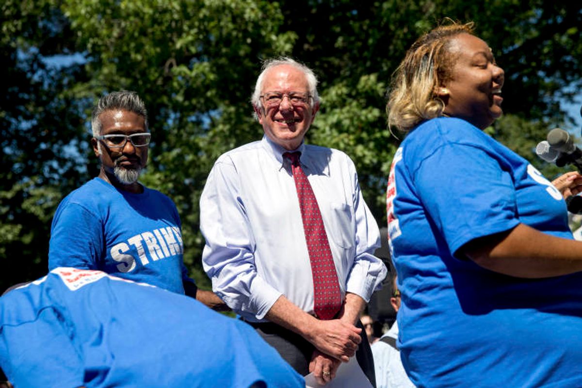 Democratic presidential candidate Sen. Bernie Sanders, I-Vt., center, joins federal contract workers to speak during a rally on Capitol Hill in Washington, Wednesday, July 22, 2015, to push for a raise to the minimum wage to $15 an hour. (AP Photo/Andrew Harnik) (AP)
