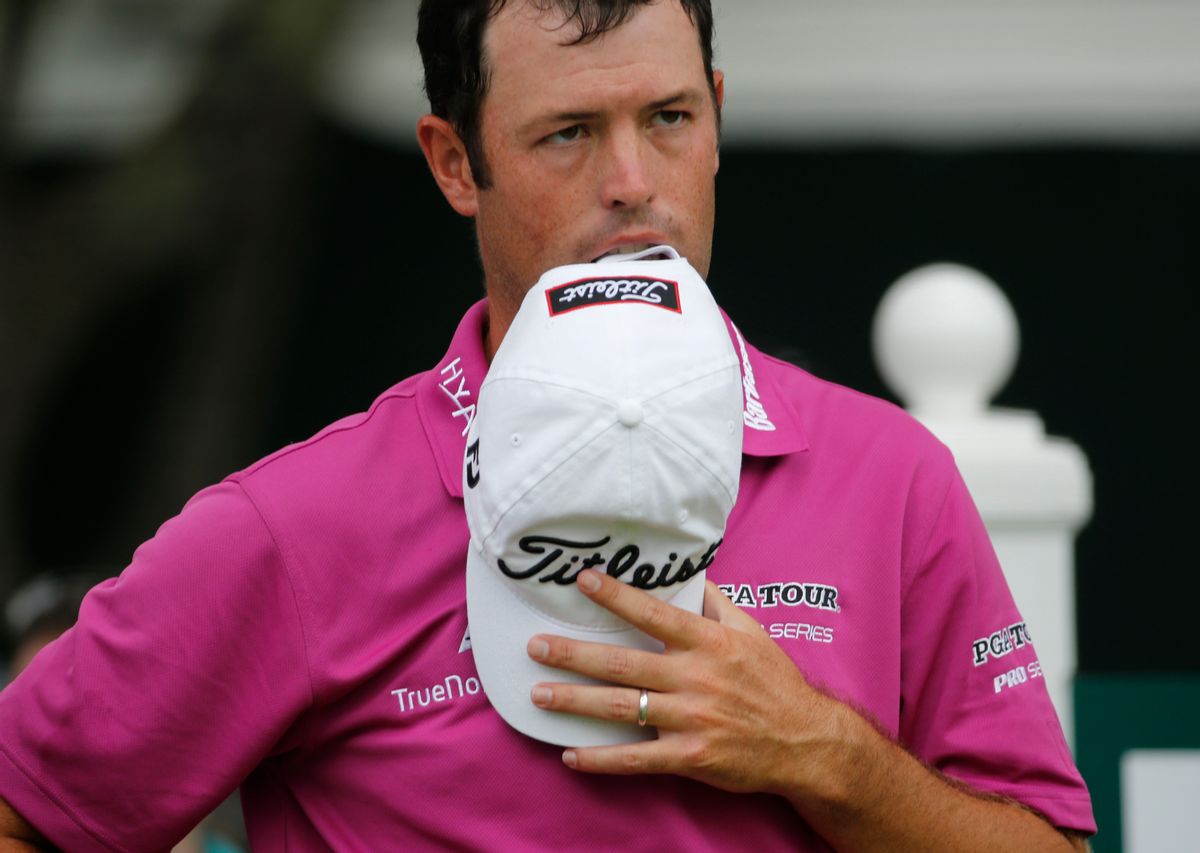 Robert Streb takes a bite out of his hat as he waits to hit on the 18th tee during the final round of the Greenbrier Classic golf tournament at the Greenbrier Resort  in White Sulphur Springs, W.Va., Sunday, July 5, 2015.  Streb broke his putter earlier in the round and was not allowed to replace it.  Streb finished at 13-under and made it to the first playoff hole.  (AP Photo/Steve Helber) (AP)