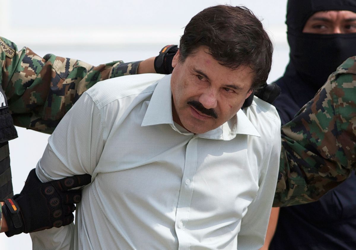 In this Feb. 22, 2014, file photo, Joaquin "El Chapo" Guzman, head of Mexicos Sinaloa Cartel, is escorted to a helicopter in Mexico City, following his capture. He escaped and was caught again on Friday. (AP)