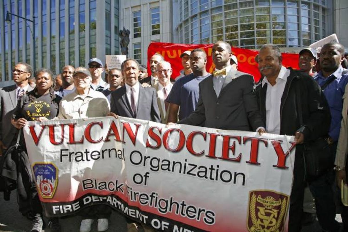  Black firefighters and Vulcan Society members celebrate the ruling in their favor outside a Brooklyn courthouse in 2013 after a 10-year battle with a Title VII discrimination lawsuit against New York City and the FDNY.    (Michel Friang)