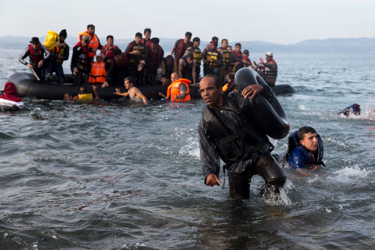 Migrants and refugees arrive on a dinghy after crossing from Turkey to Lesbos island, Greece, Wednesday, Sept. 9, 2015. The head of the European Union's executive says 22 of the member states should be forced to accept another 120,000 people in need of international protection who have come toward the continent at high risk through Greece, Italy and Hungary. (AP Photo/Petros Giannakouris) (AP)