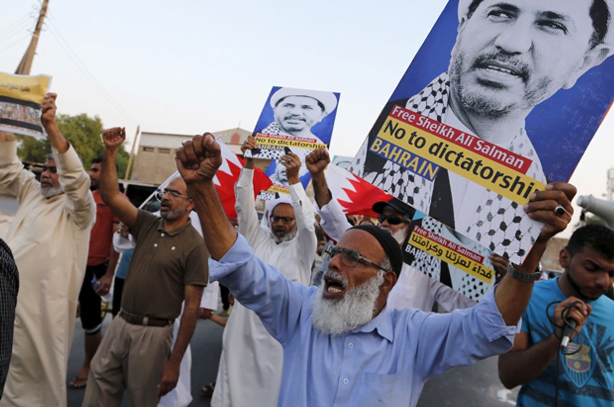 Protesters hold placards with photos of opposition leader and head of Al Wefaq party, Ali Salman, during a protest in the village of Karzakan south of Manama, Bahrain, October 3, 2015.    (Reuters/Hamad I Mohammed)