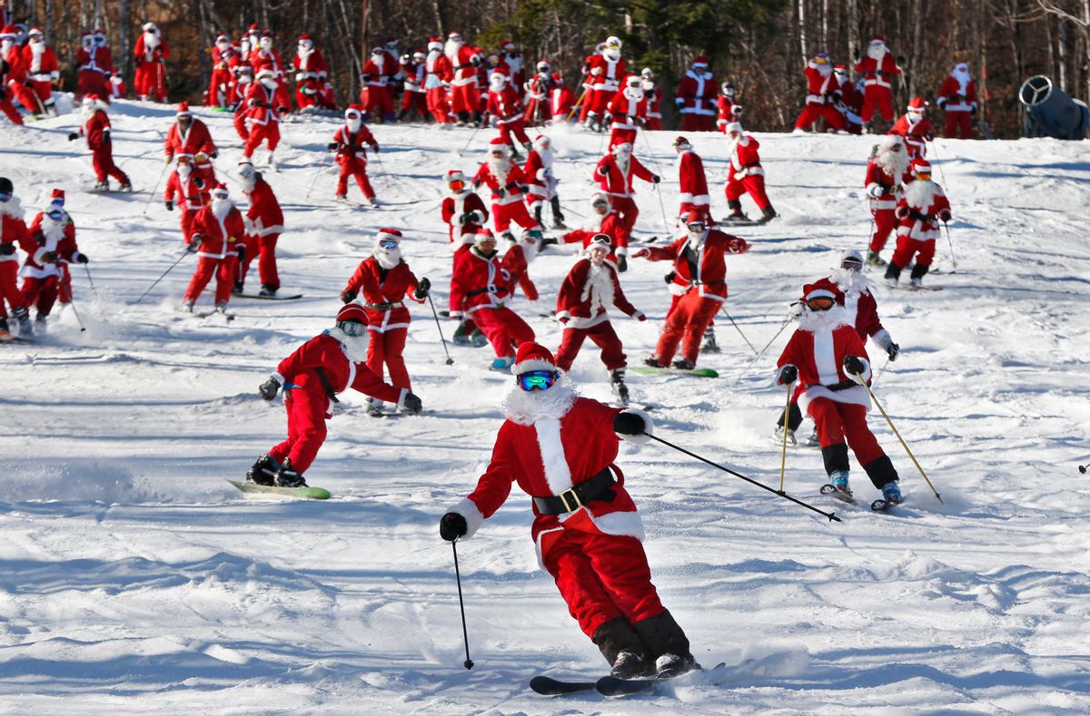 Skiers and snowboarders dressed as Santa take a run en masse at the Sunday River ski resort, Sunday, Dec. 6, 2015, in Newry, Maine. Skiers with full Santa outfits got free lift tickets for donating $15 to the Sunday River Community Fund. (AP Photo/Robert F. Bukaty) (AP)