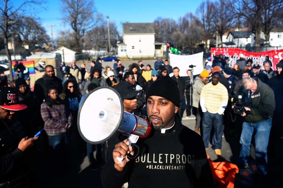 Danny Givens Jr. of St. Paul, Minnesota speaks to a gathering crowd of the group Black Lives Matter before they march to city hall during a protest in Minneapolis, Minnesota November 24, 2015.   (Reuters/Craig Lassig)