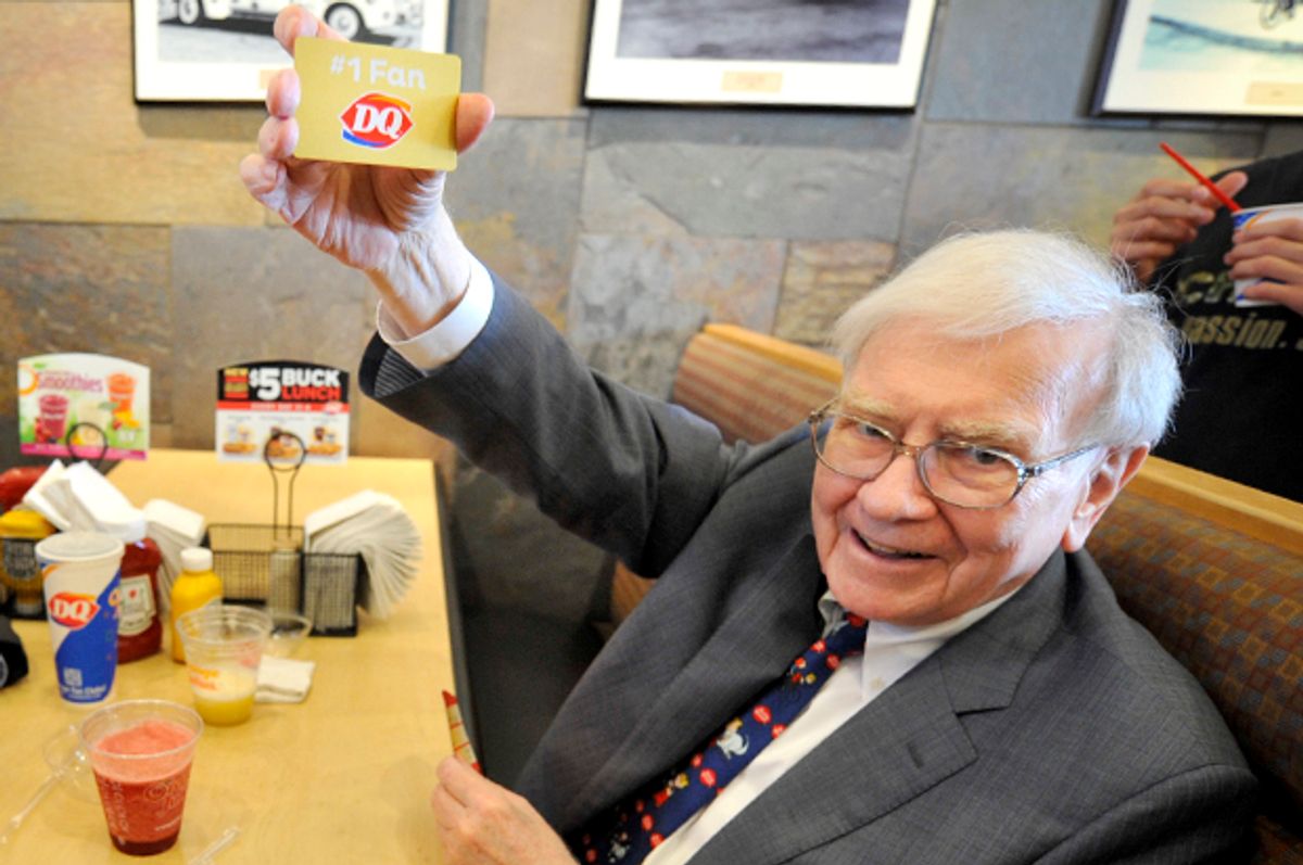Warren Buffett holds a Dairy Queen gold gift card, Monday May 20, 2013 in Omaha, Neb.   (AP/Dave Weaver)