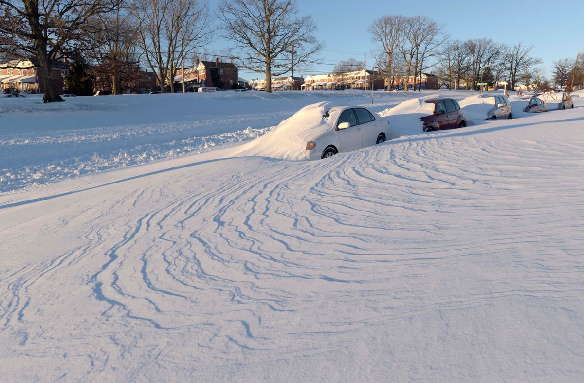Wind-blown snow buries vehicles, Sunday, Jan. 24, 2016, in Parkville, Md. Millions of Americans were preparing to dig themselves out Sunday after a mammoth blizzard with hurricane-force winds and record-setting snowfall brought much of the East Coast to an icy standstill. (AP Photo/Steve Ruark) (AP)