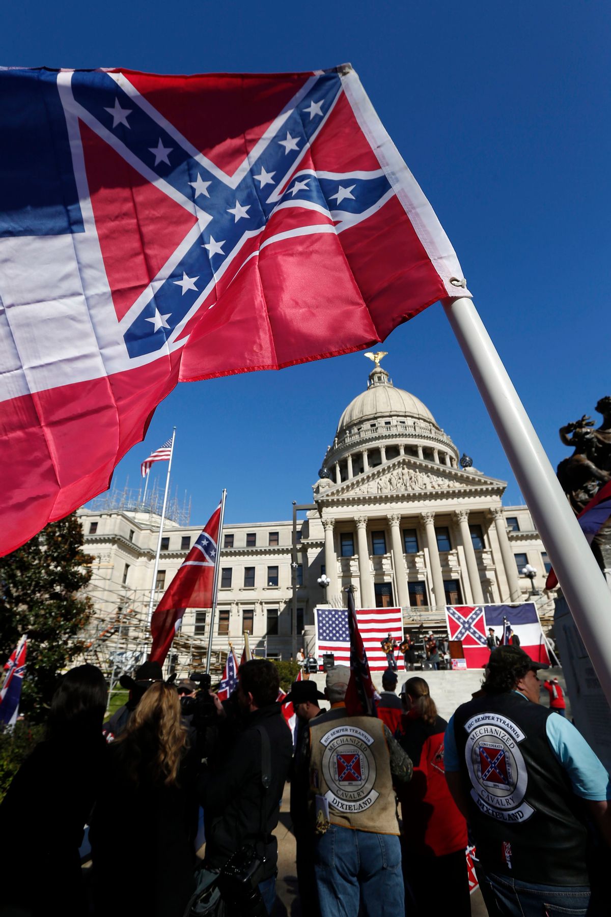 Sons of Confederate Veterans and other groups parade on the grounds of the state Capitol in Jackson, Miss., Tuesday, Jan. 19, 2016, in support of keeping the Confederate battle emblem on the state flag. The public display of Confederate symbols has come under increased scrutiny since June, when nine black worshippers were massacred at a church in South Carolina.(AP Photo/Rogelio V. Solis) (AP)