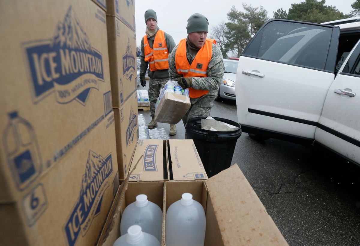 Members of the Michigan National Guard load bottled water at a fire station, Thursday, Jan. 28, 2016 in Flint, Mich. The Michigan Legislature voted Thursday to direct another $28 million to address Flint's water emergency, allocating money for bottled water, medical assessments and other costs in the city struggling with a lead-contaminated supply. (AP Photo/Carlos Osorio) (AP)