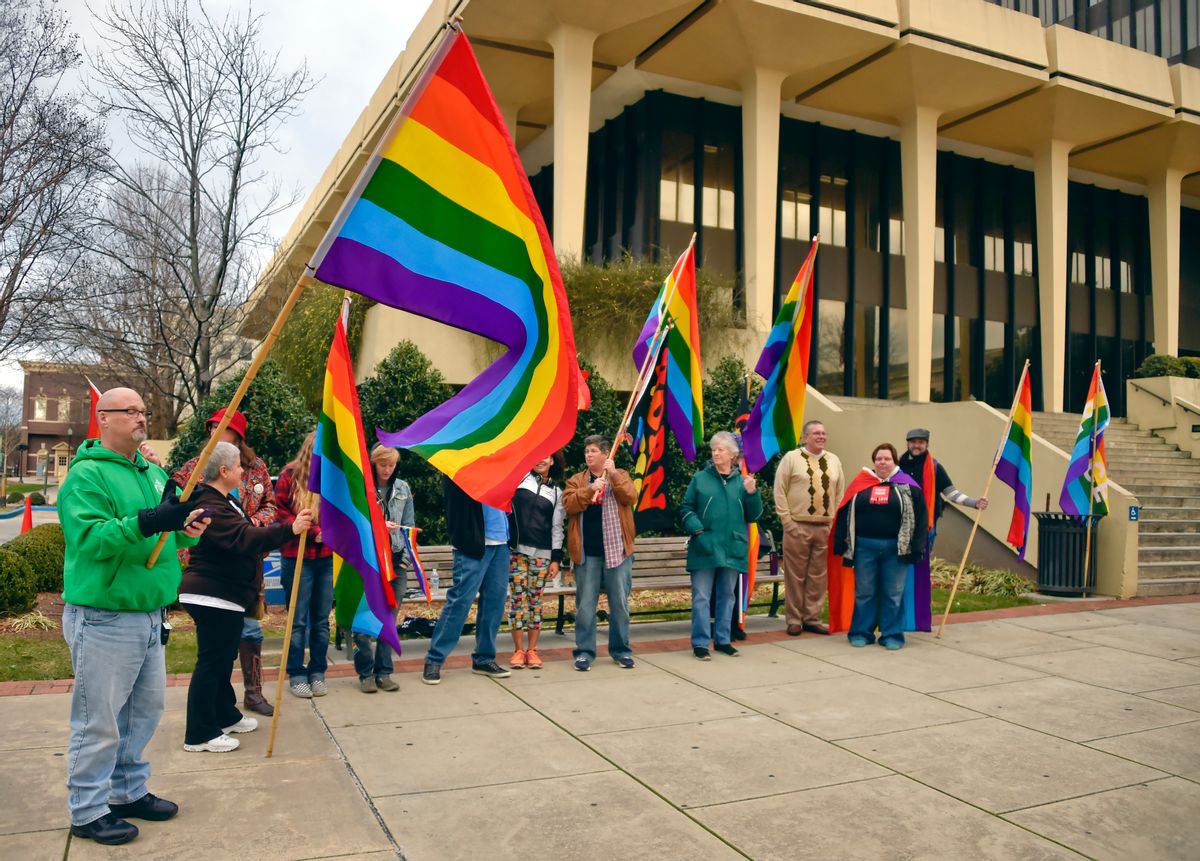 In this photo taken Wednesday, Jan. 6, 2016, Gay marriage activists gather outside the Madison County Courthouse in Huntsville, Ala., to protest Alabama Chief Justice Roy Moore's administrative order saying the Alabama Supreme Court never lifted a March directive to probate judges to refuse marriage licenses to gay couples. (Bob Gathany/AL.com via AP) MANDATORY CREDIT, MAGS OUT, TV OUT (AP)