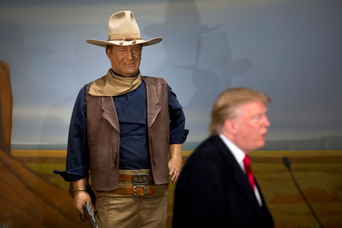 Republican presidential candidate Donald Trump stands in front of a wax statue of John Wayne during a news conference at the John Wayne Museum, Tuesday, Jan. 19, 2016, in Winterset, Iowa. (AP Photo/Jae C. Hong) (AP)