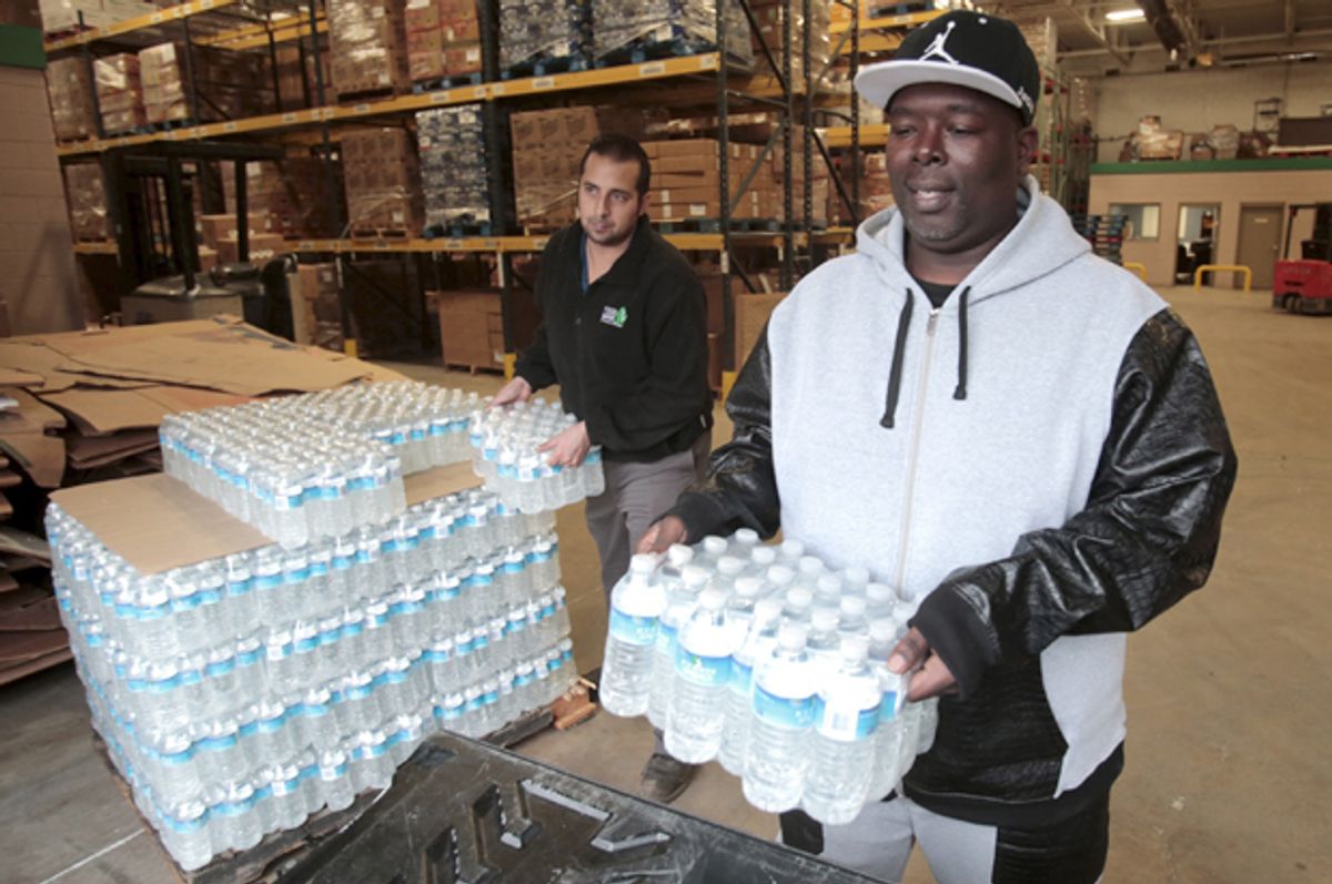 Bottled water is picked up from the Food Bank of Eastern Michigan to deliver to a school after elevated lead levels were found in the city's water in Flint, Michigan December 16, 2015.    (Reuters/Rebecca Cook)