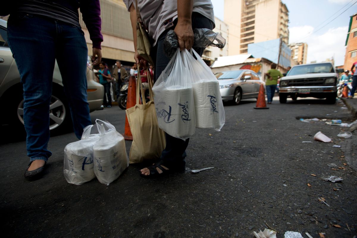 After waiting in line for hours, women stand outside a supermarket in Caracas, Venezuela, with their price regulated toilet paper made available for sale by the government, Friday, Jan. 22, 2016. In a note published Friday, the International Monetary Fund Western Hemisphere Director Alejandro Werner said inflation would more than double in the economically struggling South American country in 2016, reaching 720 percent. (AP Photo/Fernando Llano) (AP)