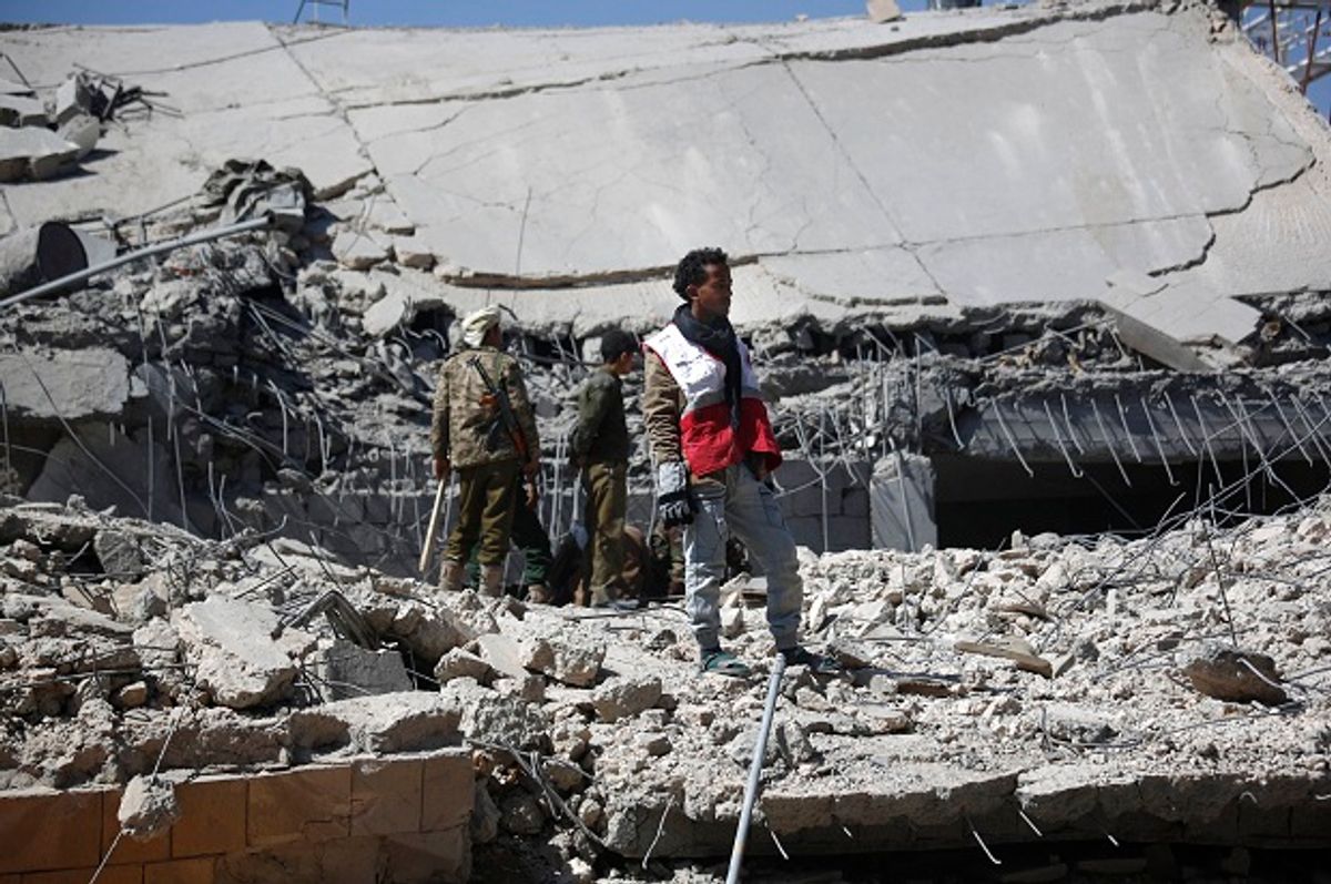 A medic stands on the rubble of the police headquarters after it was destroyed by Saudi-led airstrikes in Sanaa, Yemen, Monday, Jan. 18, 2016.  (AP/Hani Mohammed)