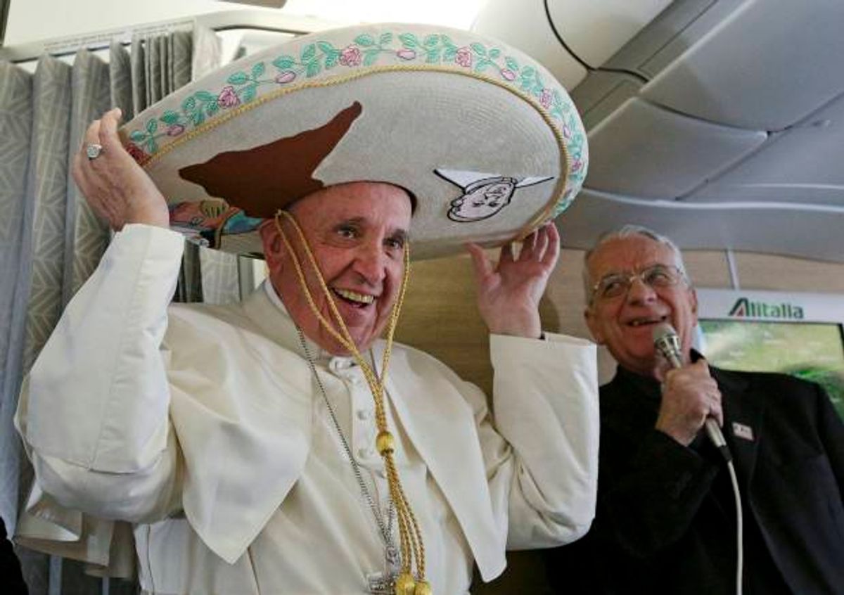Pope Francis wears a traditional Mexican sombrero hat he received as a gift by a Mexican journalist aboard the plane during the flight from Rome to Habana, Cuba, on his way to a week-long trip to Mexico, Friday, Feb. 12, 2016. The pontiff is scheduled to stop in Cuba for an historical meeting with Russian Orthodox Patriarch Kirill that the Vatican sees as a historic step in the path toward healing the 1,000-year schism that split Christianity. At right is Vatican spokesperson Rev. Federico Lombardi. (Alessandro Di Meo/Pool Photo via AP) (AP)