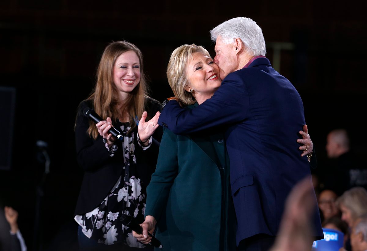 Democratic Presidential candidate Hillary Clinton gets a kiss from her husband and former President Bill Clinton as daughter Chelsea looks on during a rally at the Clark County Government Center Friday, Feb. 19, 2016. (Steve Marcus/Las Vegas Sun VIA AP) (AP)