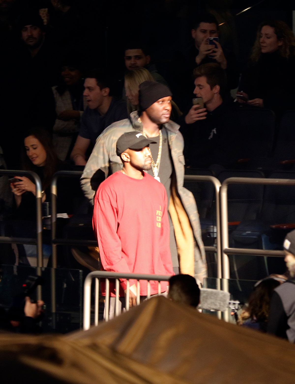 Lamar Odom, background, and Kanye West enter Madison Square Garden for the unveiling of the Yeezy collection and album release for West's latest album, "The Life of Pablo," Thursday, Feb. 11, 2016 during Fashion Week in New York. (AP Photo/Bruce Barton) (AP)