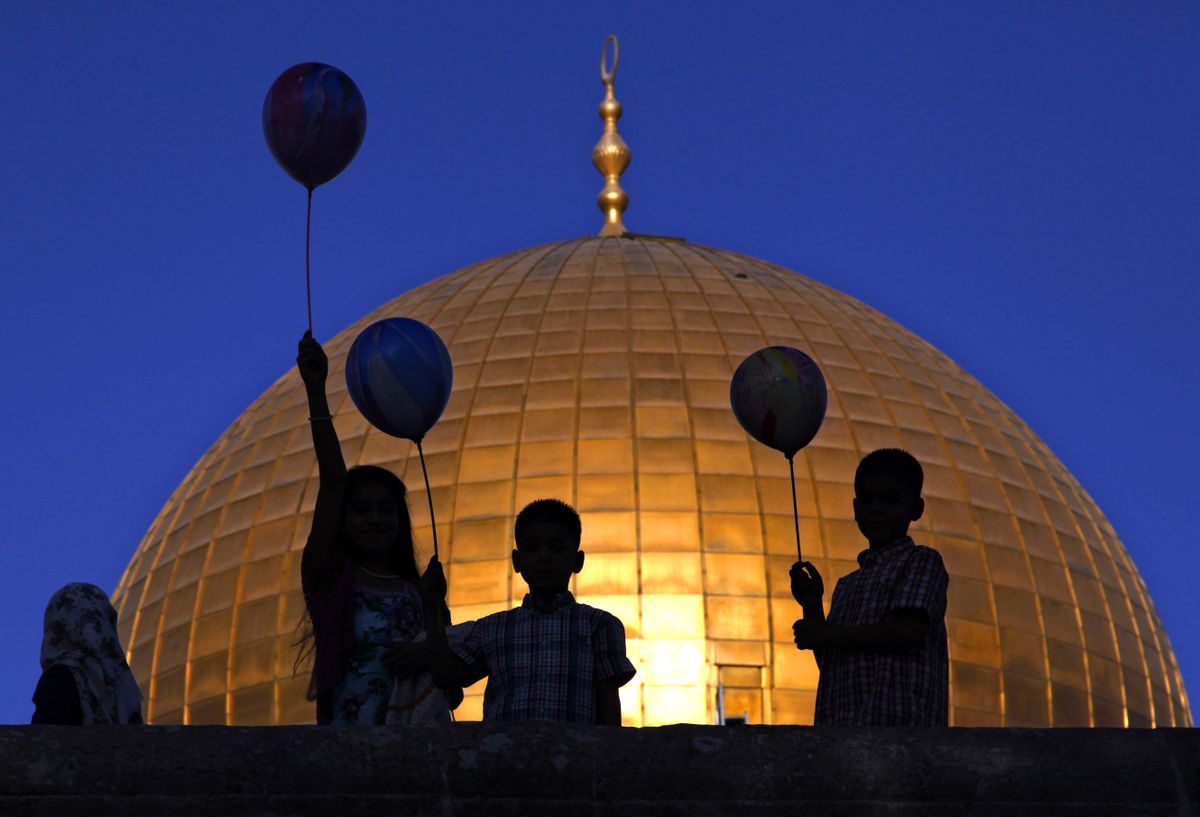 FILE - In this Thursday, Sept. 24, 2015 file photo, Palestinian children hold balloons during the Muslim holiday of Eid al-Adha, near the Dome of the Rock Mosque in the Al Aqsa Mosque compound in Jerusalem's Old City. Video surveillance of the Holy Land's most sensitive shrine was meant to be a quick fix for lowering tensions that have driven months of Israeli-Palestinian violence, but disputes over who would controls the footage and what it could show appear to be holding up the installation of the cameras. (AP Photo/Mahmoud Illean, File) (AP)