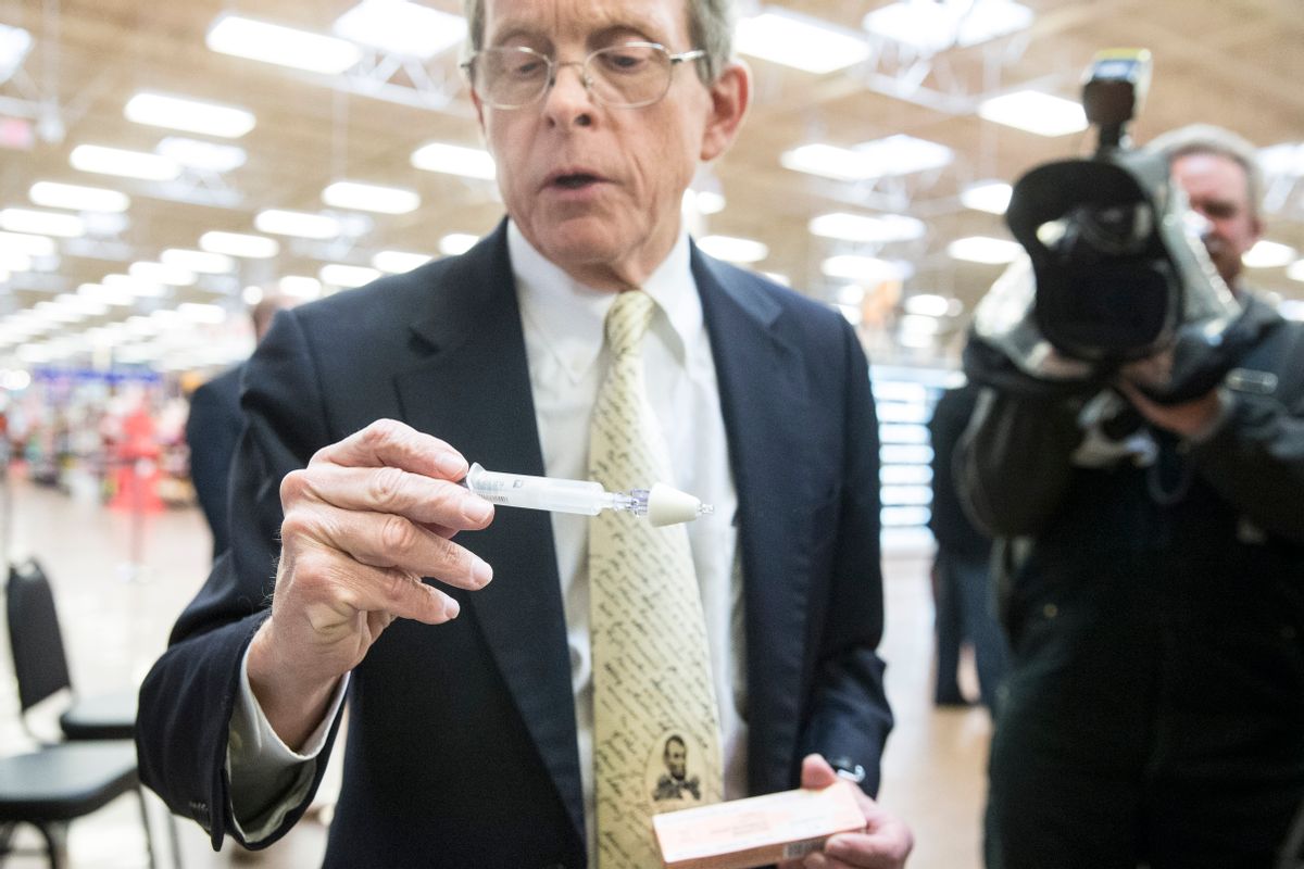 Ohio Attorney General Mike DeWine handles a Naloxone nasal injector during a news conference at the Oakley Kroger Marketplace store to announce the supermarket chain's decision to offer the opioid overdose reversal medicine without a prescription, Friday, Feb. 12, 2016, in Cincinnati. Naloxone is routinely carried by fire-rescue crews, which use it thousands of times a year in Ohio to revive overdose victims. Kroger, based in Cincinnati, has 2,774 supermarkets and multi-department stores in 35 states and the District of Columbia. (AP Photo/John Minchillo) (AP)