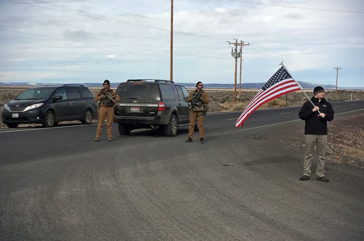 Armed law enforcement officers stand near a closed highway about 4 miles outside of the Malheur National Wildlife Refuge in Burns, Ore, after the last four occupiers of the national nature preserve surrendered on Thursday, Feb. 11, 2016.   (AP/Rebecca Boone)