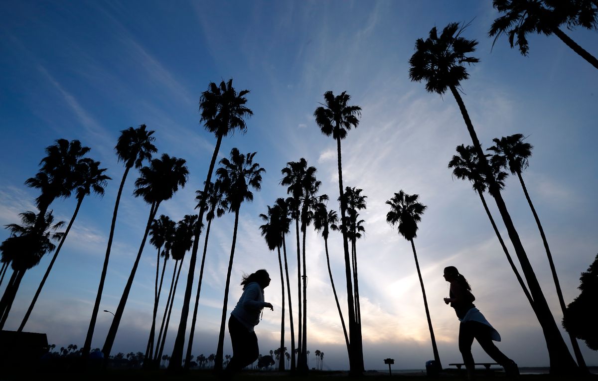 FILE - In this Feb. 23, 2016, file photo, women run as the sun sets in San Diego. Winter, especially in the southern half of the state, has been dry, and rain and snowfall in the weeks ahead would have to be extensive to make up lost ground in the state, even with the current forecast of a series of early March storms heading directly toward California. (AP Photo/Gregory Bull, File) (AP)