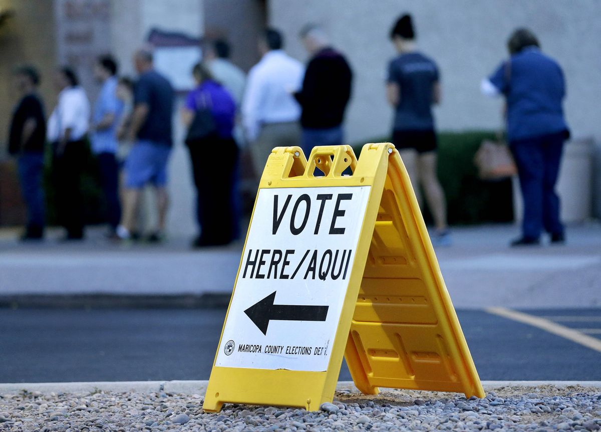 Voters wait in line at dawn to cast their ballot in Arizona's presidential primary election, Tuesday, March 22, 2016, in Phoenix. (AP Photo/Matt York) (AP)