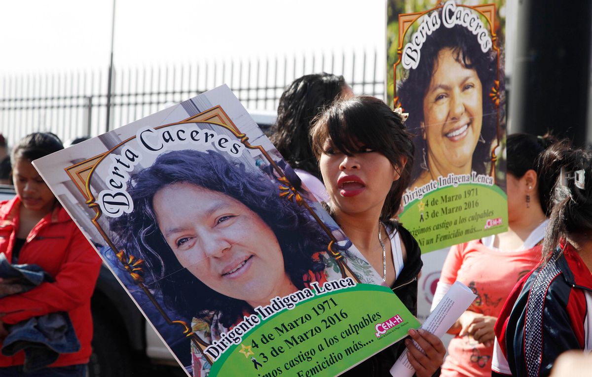 Women carry images of slain environmental activist Berta Caceres during the commemoration of International Women's Day in Tegucigalpa, Honduras, Tuesday, March 8, 2016. Caceres, a Lenca Indian activist who won the 2015 Goldman Environmental Prize for her role in fighting a dam project was killed by unknown assailants on March 3, 2016. She had previously complained of receiving death threats from police, soldiers and local landowners because of her work. (AP Photo/Fernando Antonio) (AP)