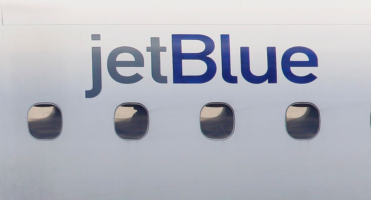 FILE - In this Jan. 20, 2011, file photo, a JetBlue logo is displayed on the side of a jet as it taxis at Boston's Logan International Airport.  (AP)