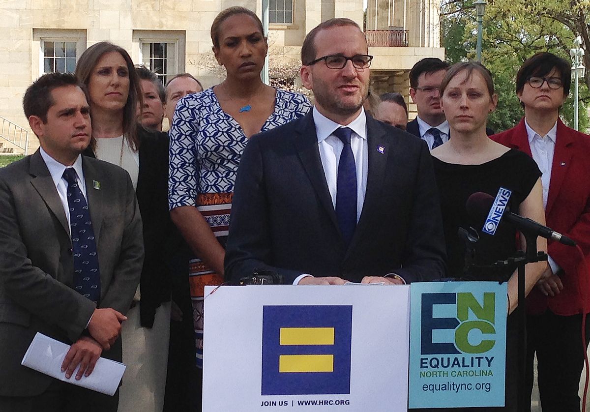 Human Rights Campaign Executive Director Chad Griffin, center, speaks at a news conference at the old state Capitol Building in Raleigh, N.C. on Thursday, March 30, 2016.  (AP/Gary Robertson)